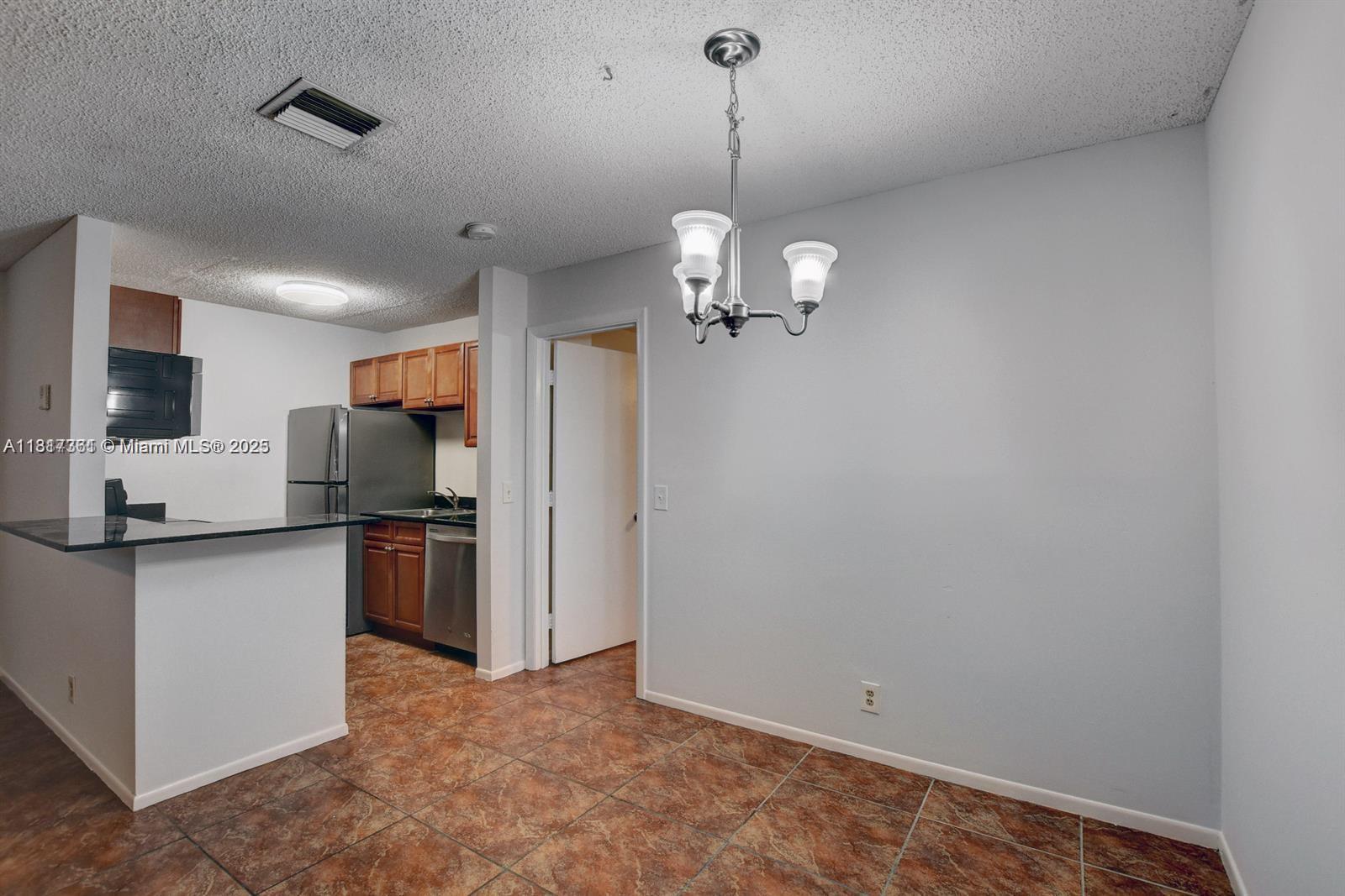a view of a kitchen with stainless steel appliances a refrigerator and a sink