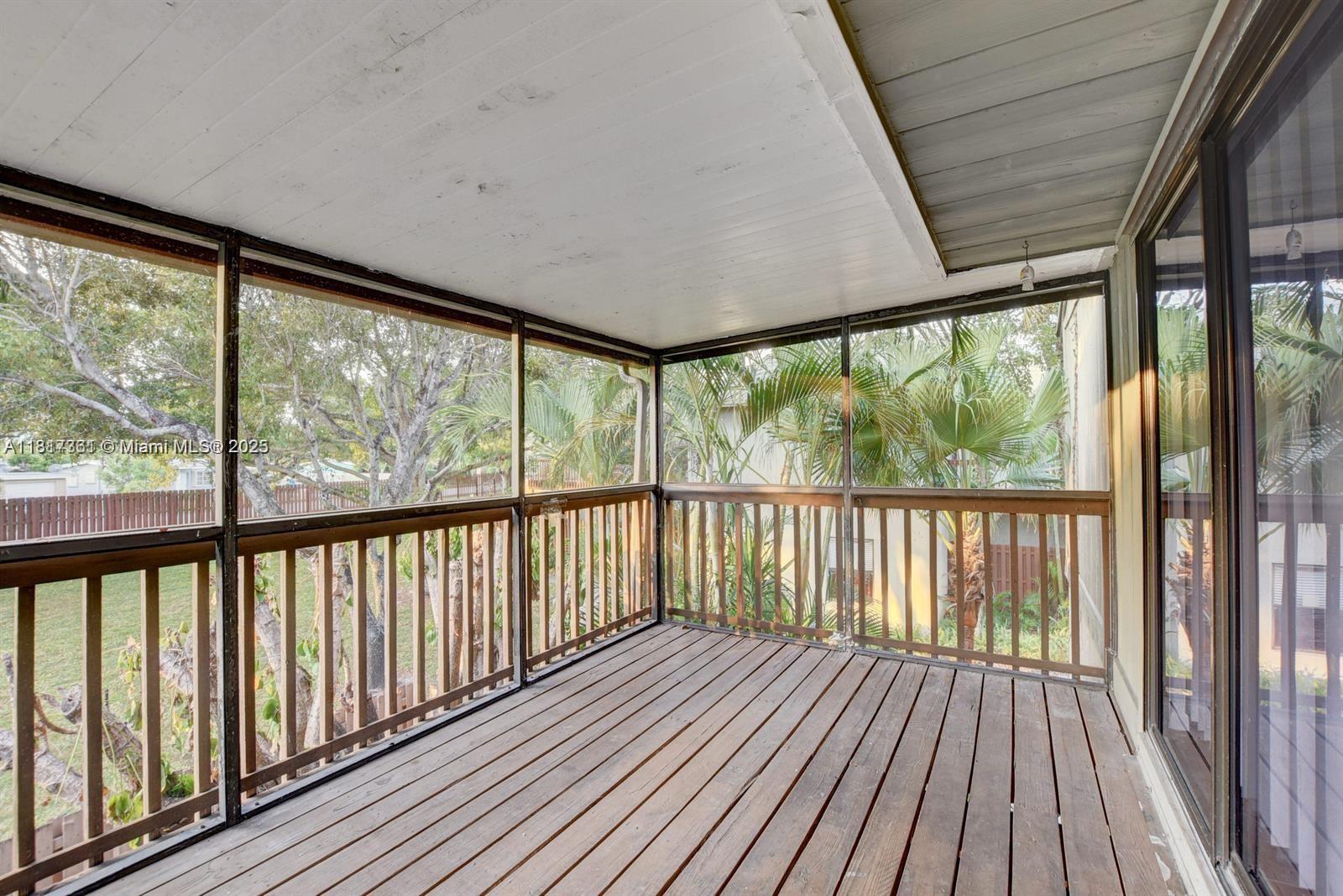 28 Crossings Circle, Unit E Boynton Beach, FL 33435 - Photo 12 of 18 a view of a large window with wooden deck