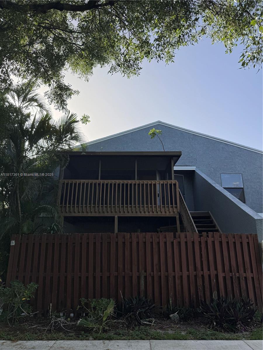 28 Crossings Circle, Unit E Boynton Beach, FL 33435 - Photo 18 of 18 a view of balcony with wooden floor and fence