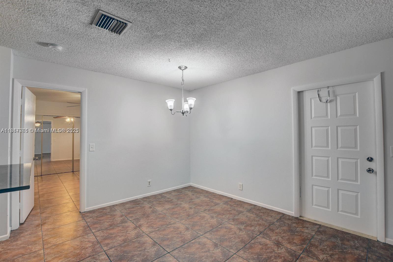28 Crossings Circle, Unit E Boynton Beach, FL 33435 - Photo 6 of 18 wooden floor in an empty room