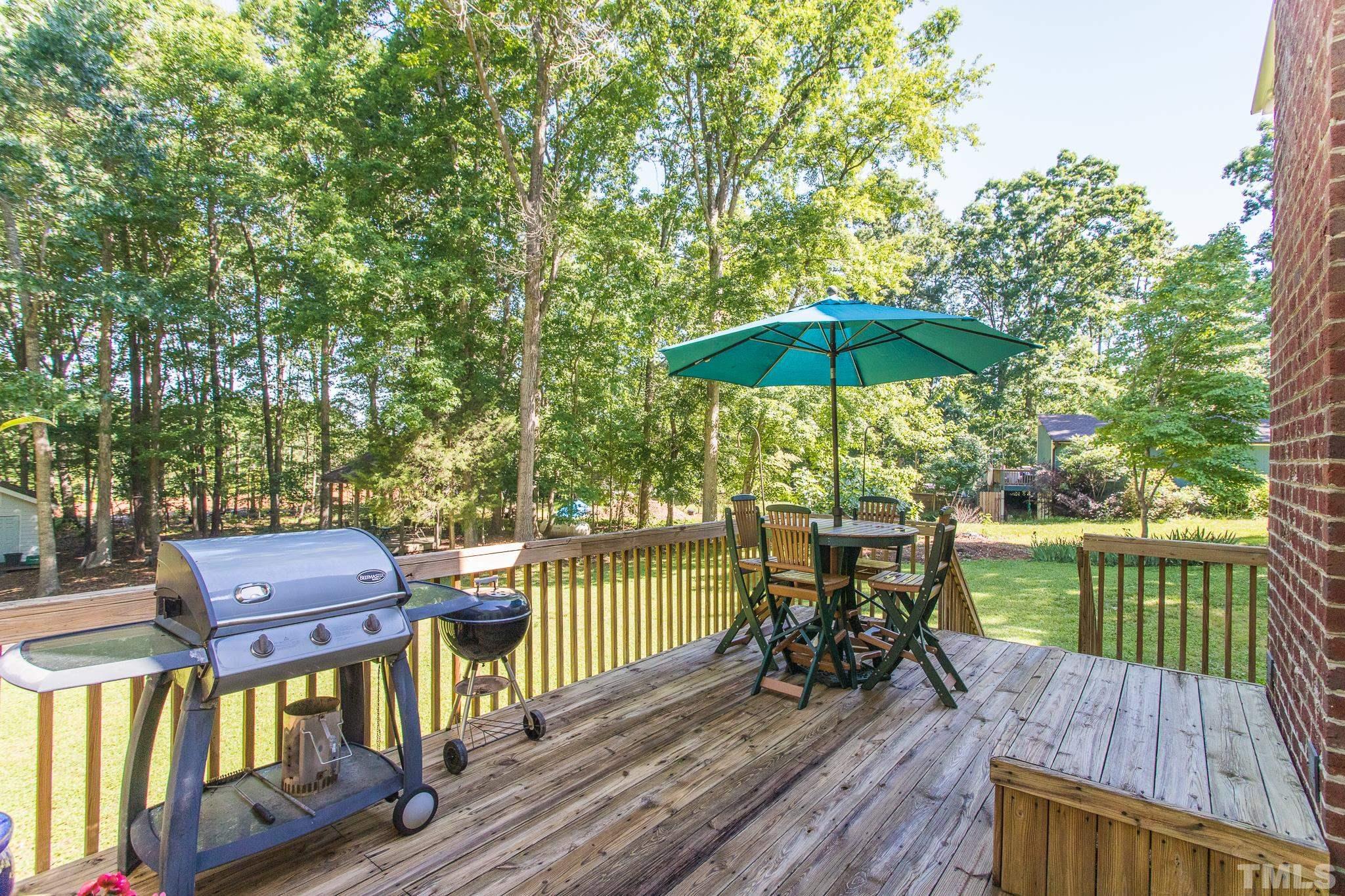 10300 Baileywick Road Raleigh, NC 27613 - Photo 24 of 26 a view of a deck with furniture and barbeque oven