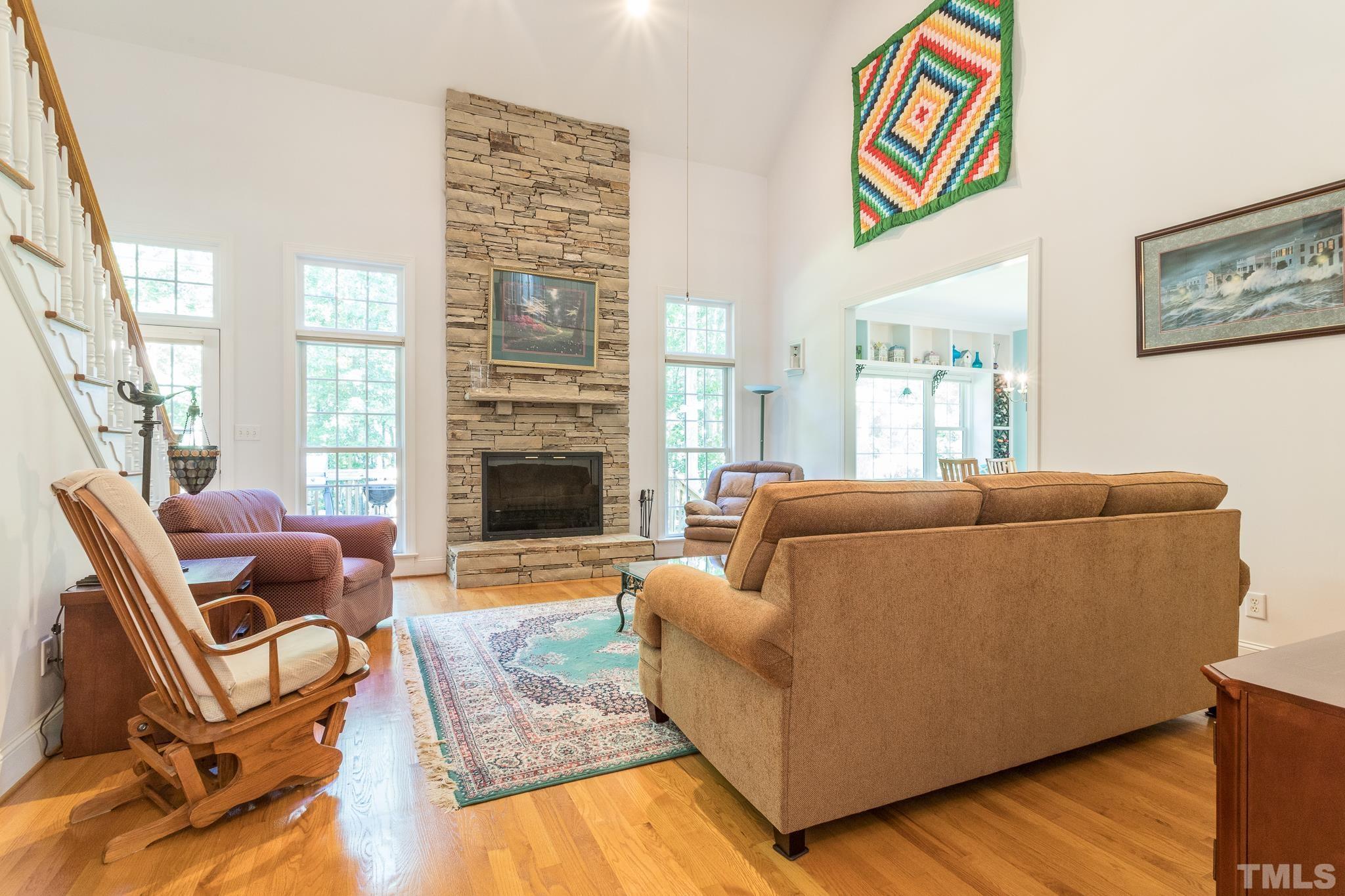 10300 Baileywick Road Raleigh, NC 27613 - Photo 5 of 26 a living room with furniture a fireplace and a large window