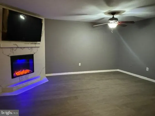 a living room with a fireplace and a television
