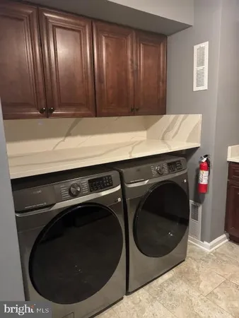 a kitchen with wooden cabinets and a stove top oven