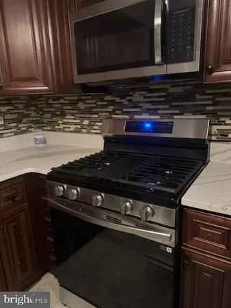 a stove top oven sitting inside of a kitchen