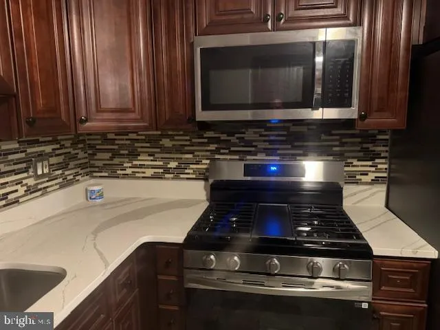 an empty room with closet and a chandelier fan