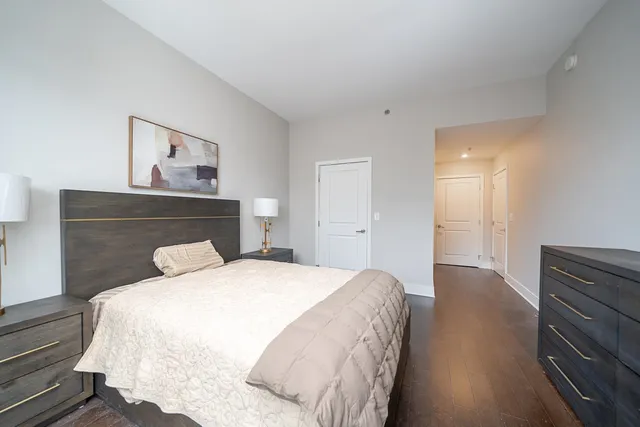 a bedroom with a bed and a painting on the wall