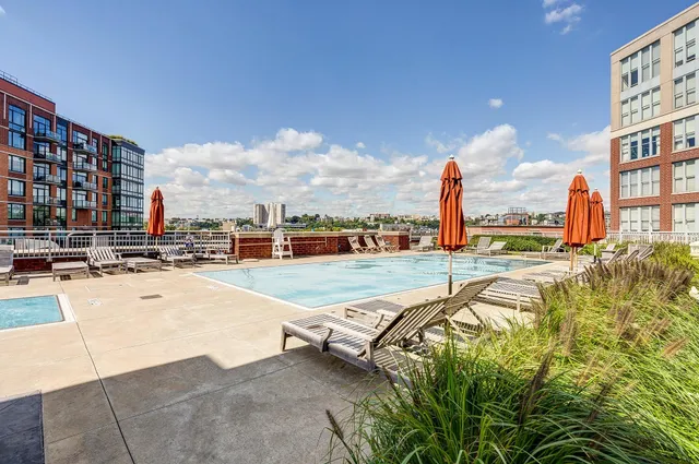 a swimming pool with outdoor seating and yard