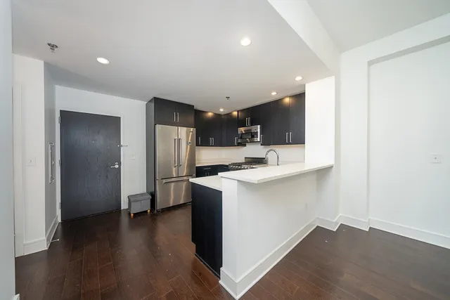 a kitchen with stainless steel appliances a refrigerator sink and microwave