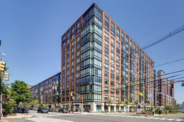 a view of a tall building next to a street
