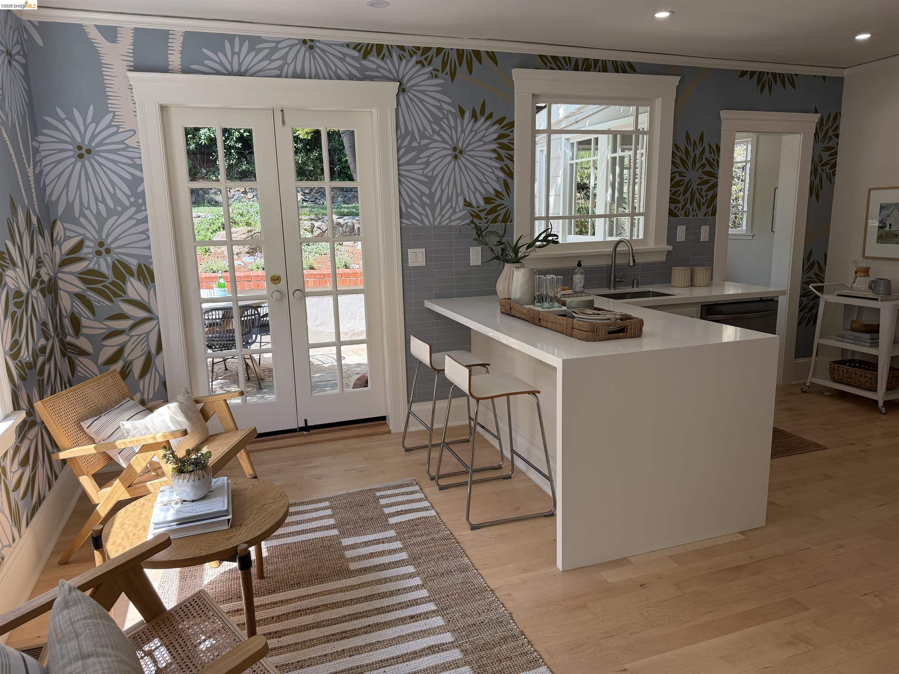 1121 Ranleigh Way Piedmont, CA 94610 - Photo 1 of 1 Doorway with french doors, wood finished floors, and wallpapered walls