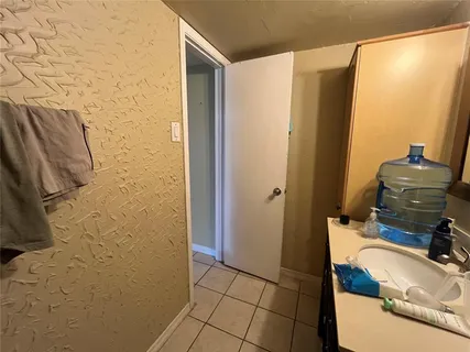 a kitchen with a refrigerator and cabinets