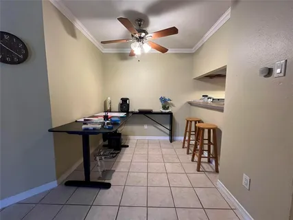 a view of a workspace with furniture and a chandelier