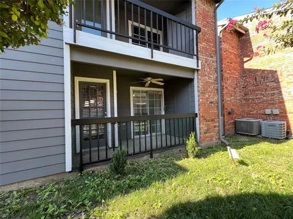 a view of a house with a backyard and porch