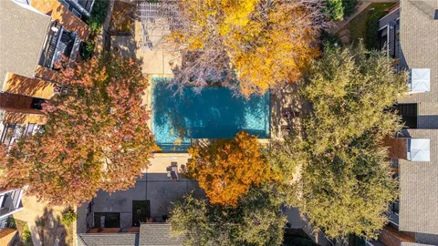 an aerial view of a house with a yard and outdoor seating