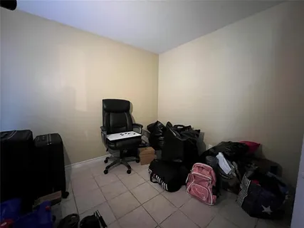 a view of a hallway with dining area and a view of bedroom