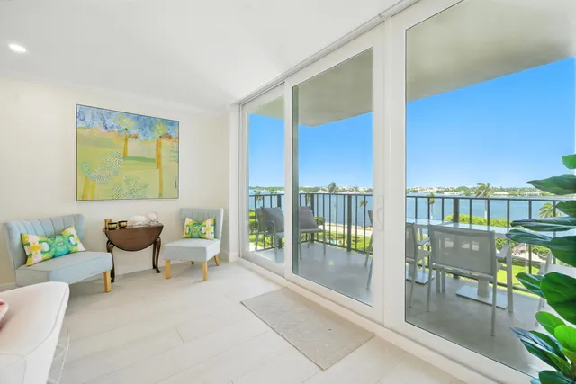a living room with furniture and a floor to ceiling window