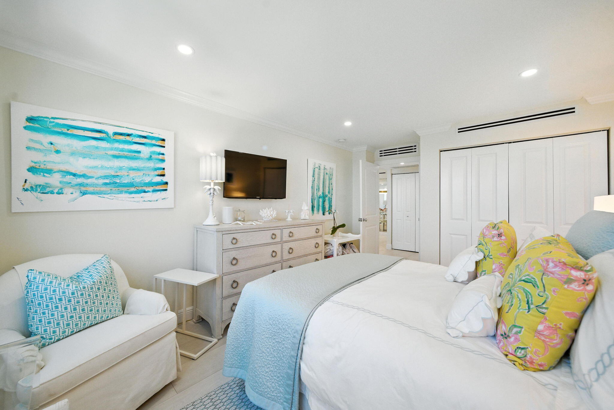 1801 South Flagler Drive, Unit 709 West Palm Beach, FL 33401 - Photo 23 of 39 a bedroom with a bed a couch and a flat screen tv