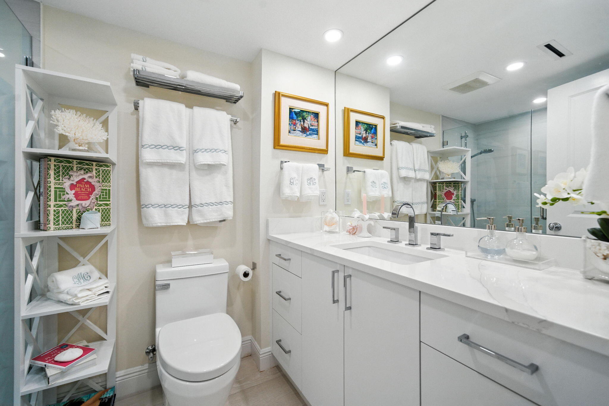 1801 South Flagler Drive, Unit 709 West Palm Beach, FL 33401 - Photo 24 of 39 a bathroom with a toilet a sink and a large mirror