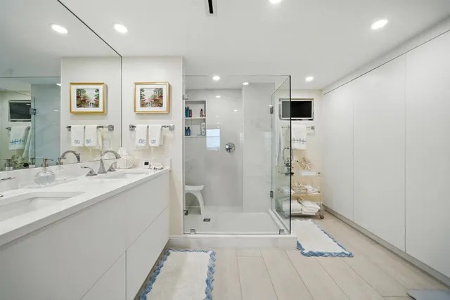 a bathroom with a tub sink shower and a mirror