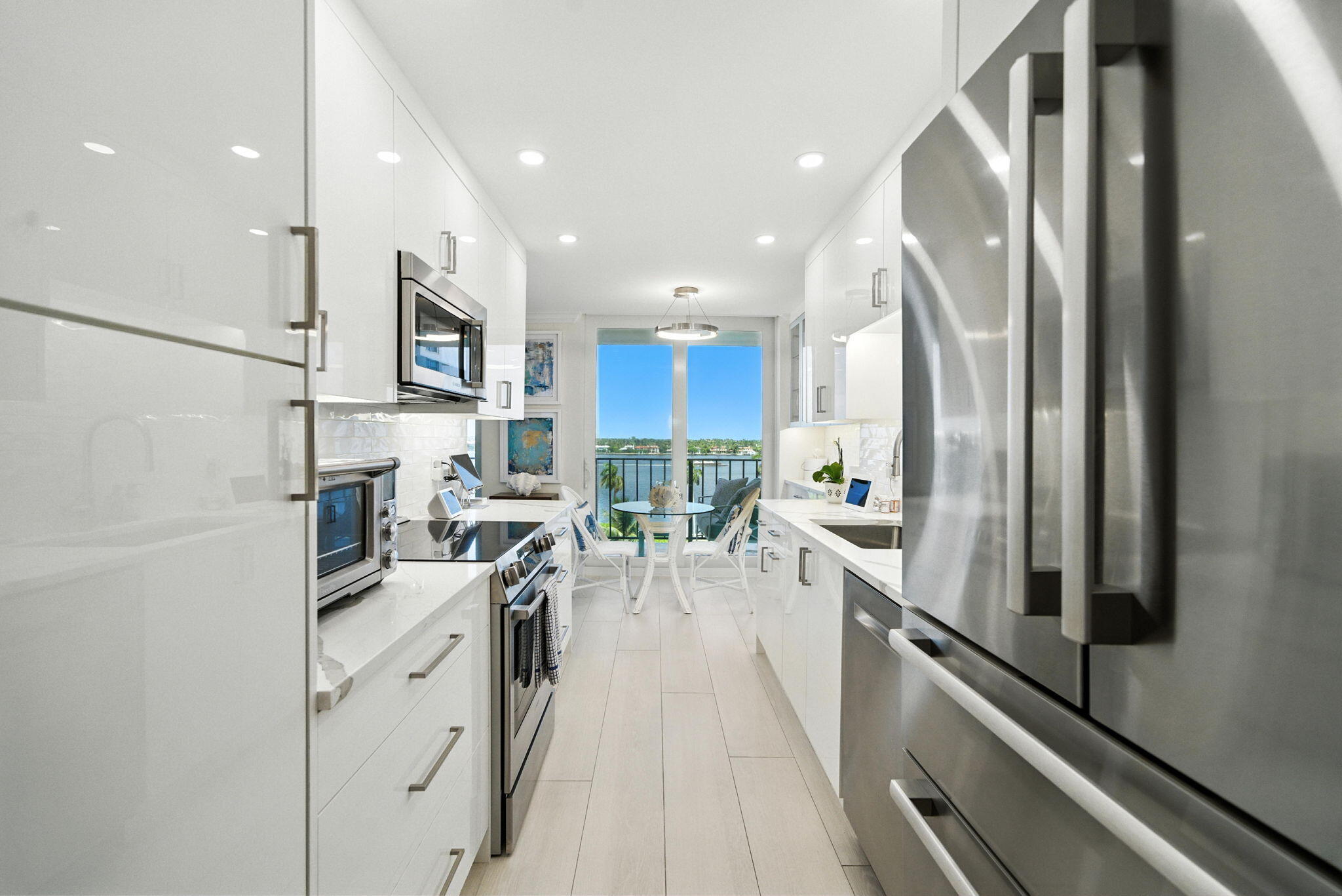 1801 South Flagler Drive, Unit 709 West Palm Beach, FL 33401 - Photo 10 of 39 a kitchen with stainless steel appliances a sink a stove a refrigerator and cabinets