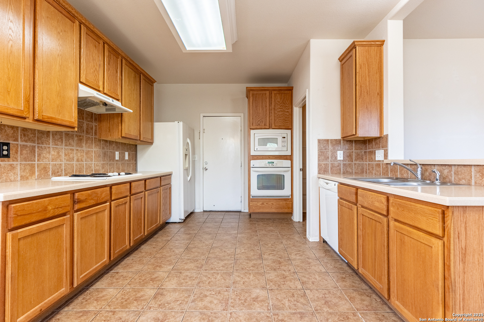 1134 Seven Iron Way San Antonio, TX 78221 - Photo 12 of 33 a large kitchen with cabinets