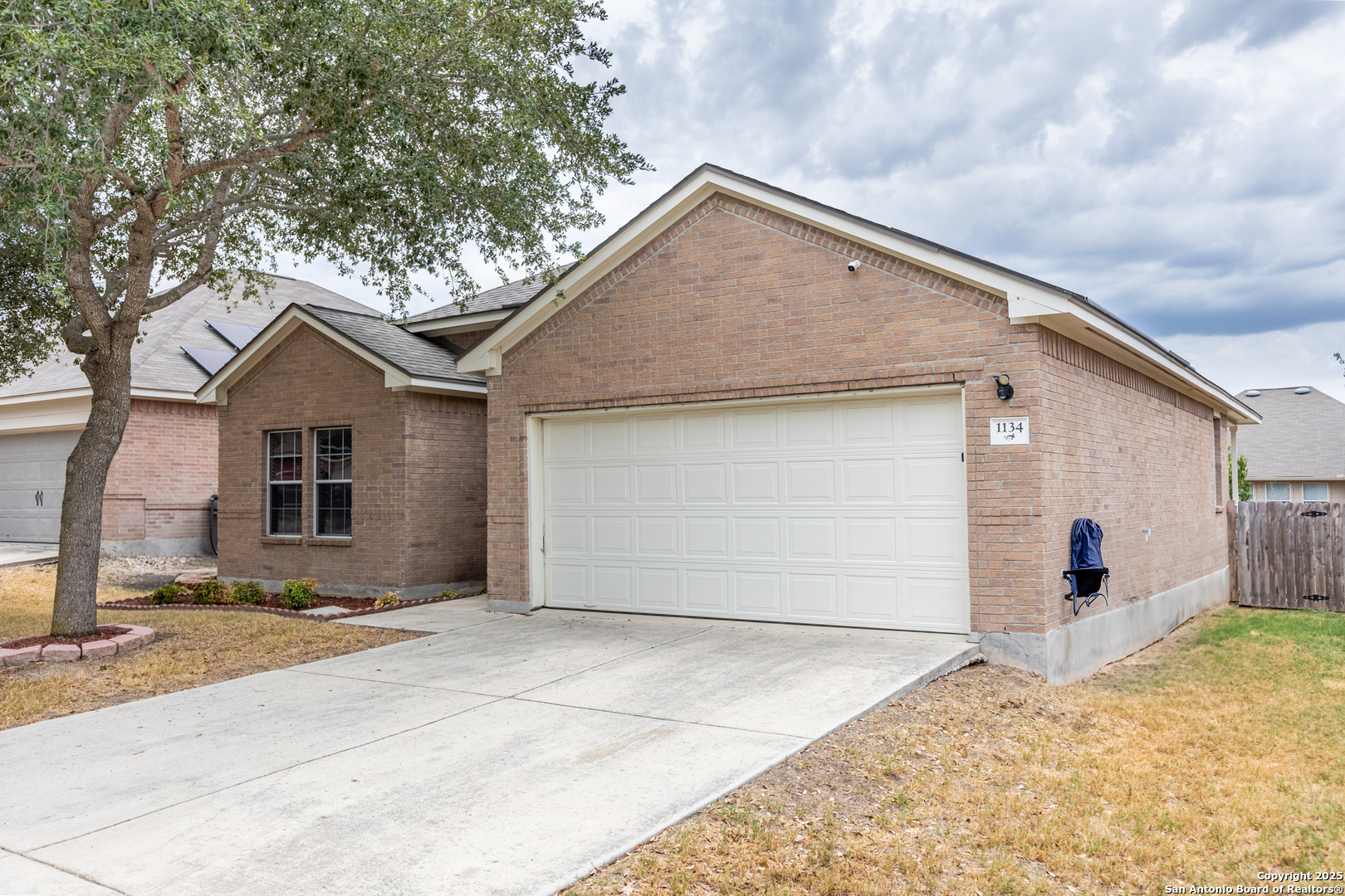 1134 Seven Iron Way San Antonio, TX 78221 - Photo 2 of 33 a view of garage yard and front view of a house