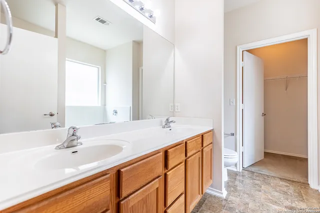 a bathroom with a tub shower and sink