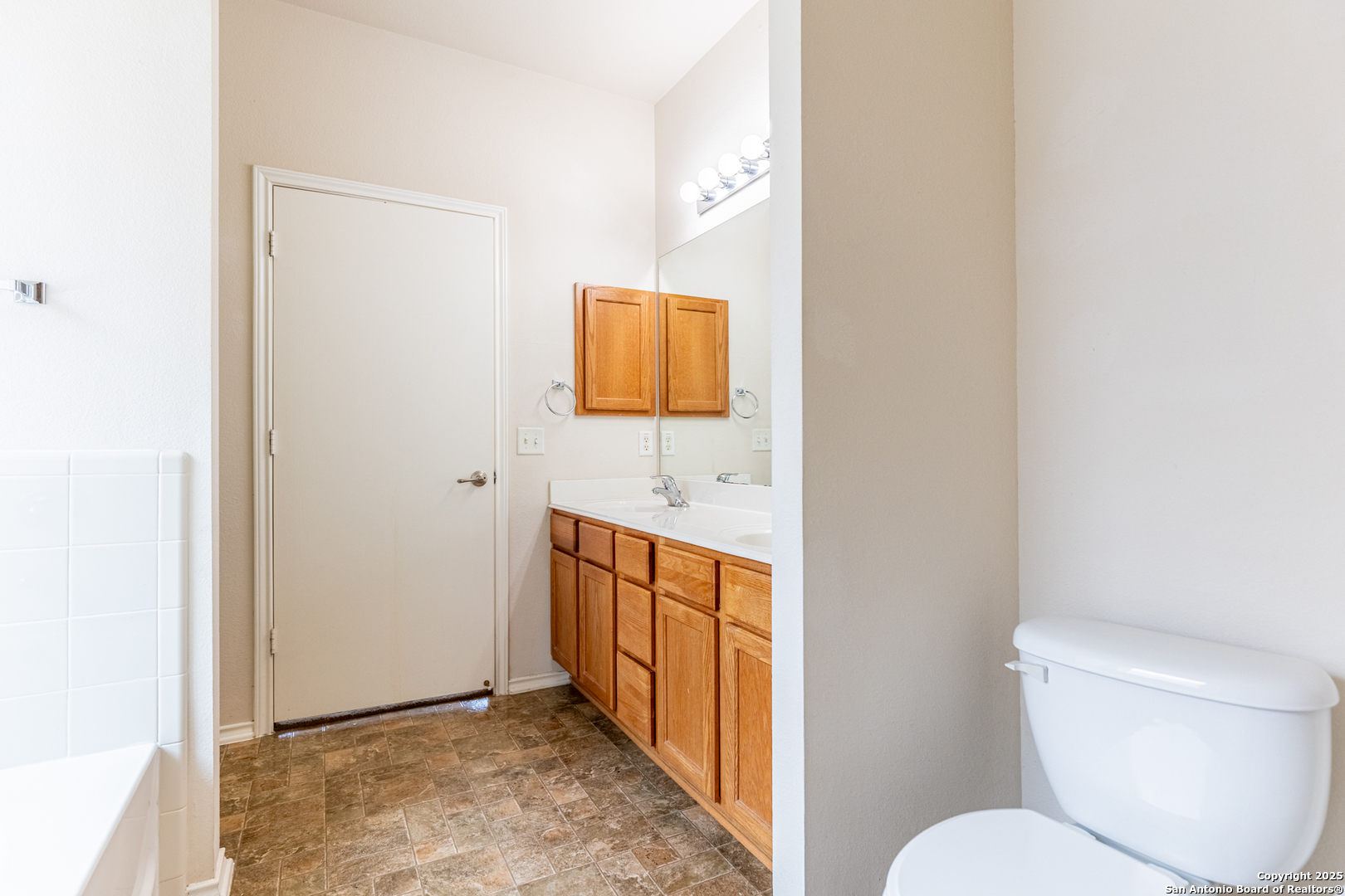 1134 Seven Iron Way San Antonio, TX 78221 - Photo 24 of 33 a bathroom with a sink toilet and mirror