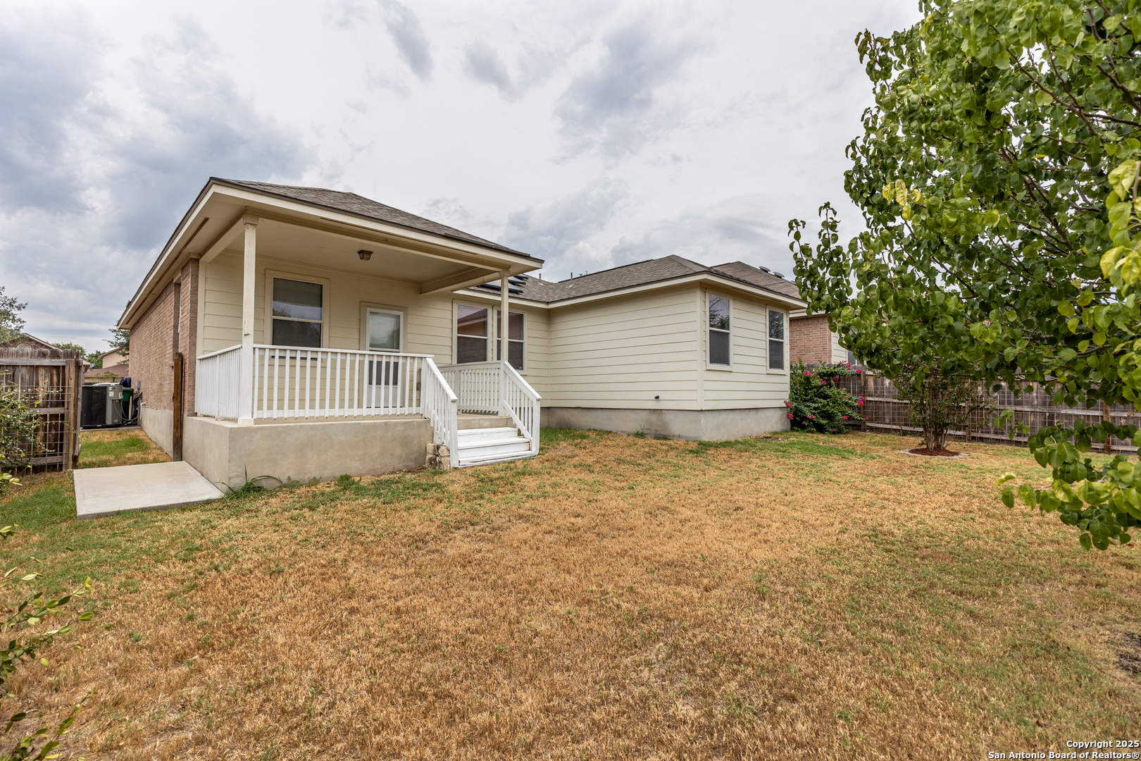 1134 Seven Iron Way San Antonio, TX 78221 - Photo 30 of 33 a front view of a house with a yard and garage