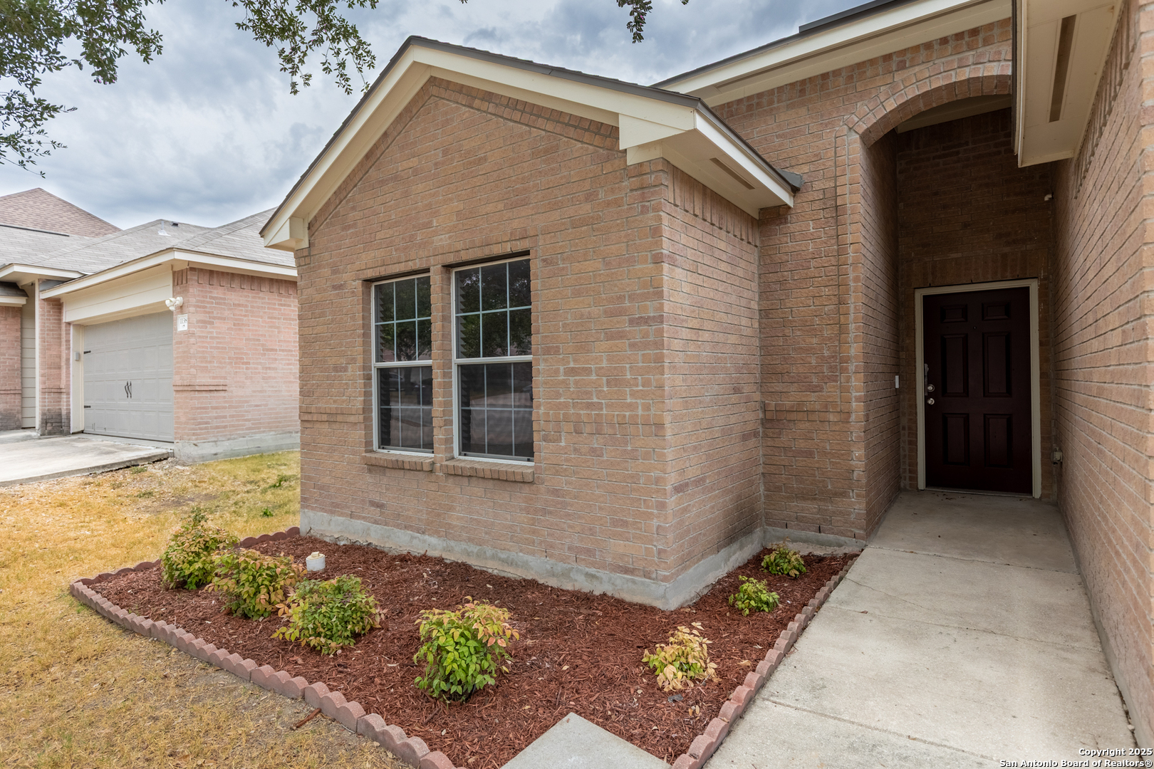 1134 Seven Iron Way San Antonio, TX 78221 - Photo 4 of 33 a front view of a house with garden