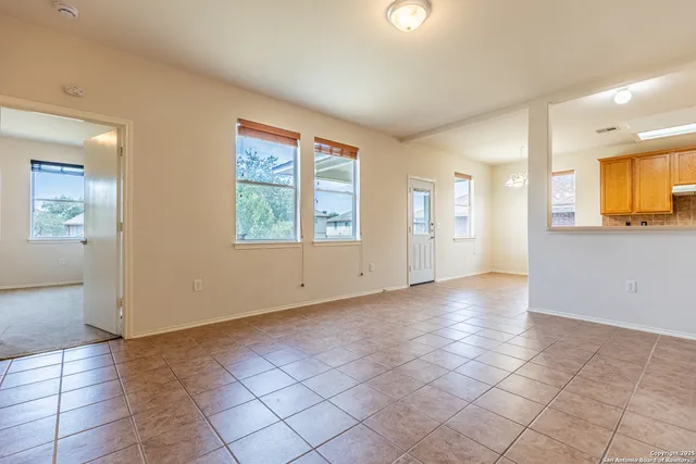 an empty room with windows and painted walls