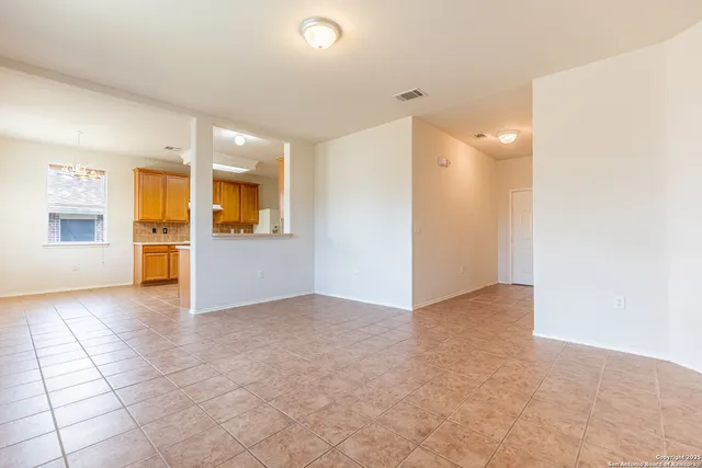 an empty room with a empty space and windows