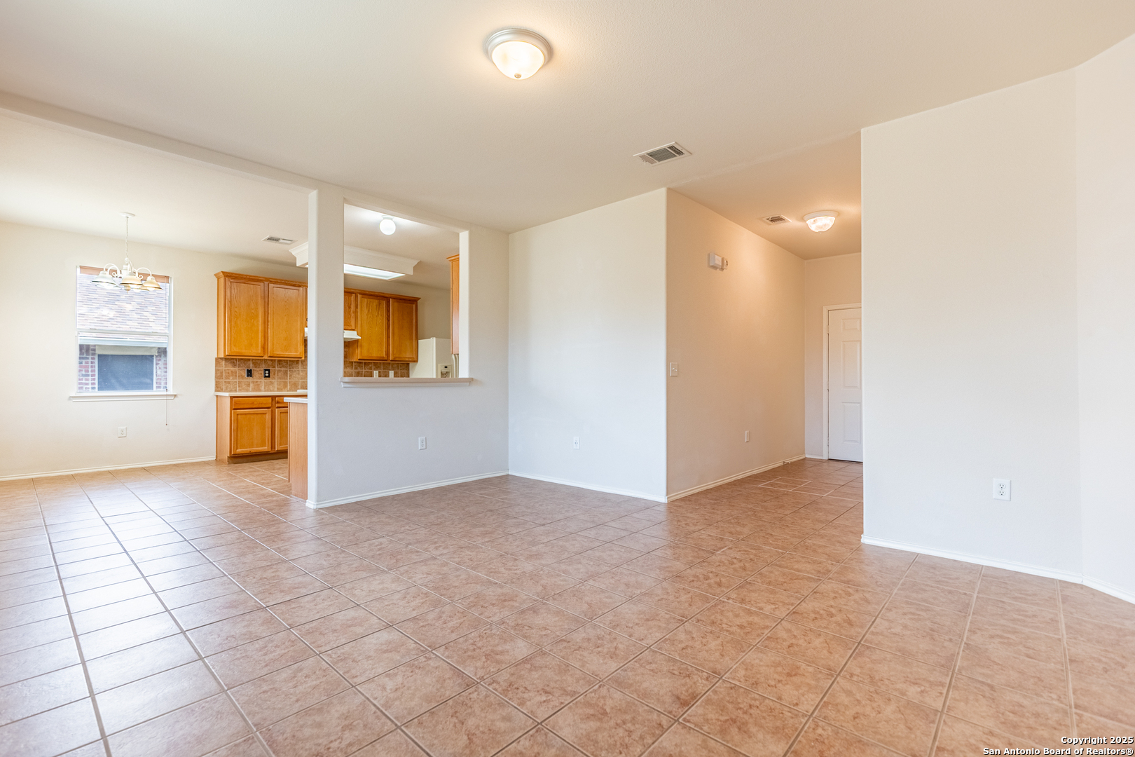 1134 Seven Iron Way San Antonio, TX 78221 - Photo 6 of 33 an empty room with a empty space and windows
