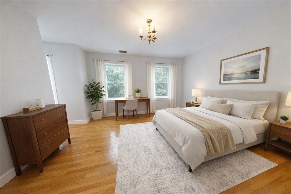 216 Summit Avenue, Unit 201 Brookline, MA 02446 - Photo 5 of 9 a spacious bedroom with a large bed and wooden floor