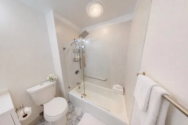 a bathroom with a toilet a sink and bathtub