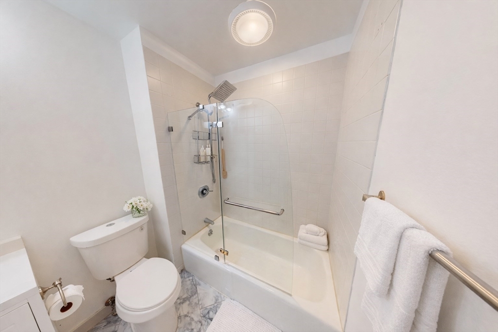 216 Summit Avenue, Unit 201 Brookline, MA 02446 - Photo 8 of 9 a bathroom with a toilet a sink and bathtub