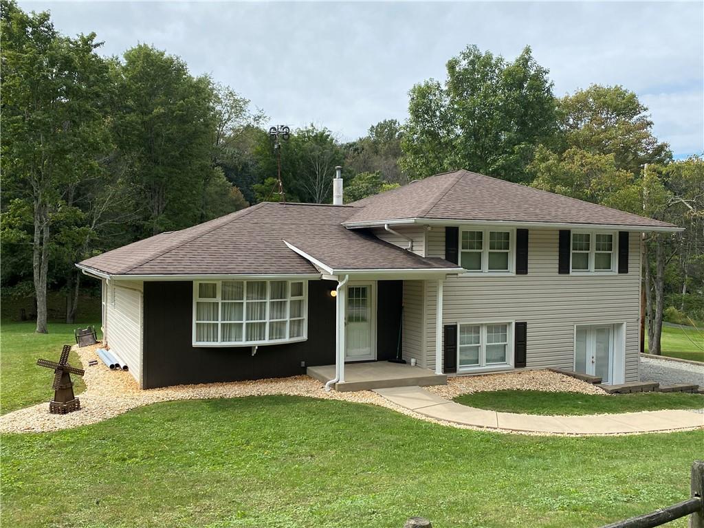 262 Thorne Run Road Export, PA 15632 - Photo 1 of 19 a front view of a house with a garden and porch