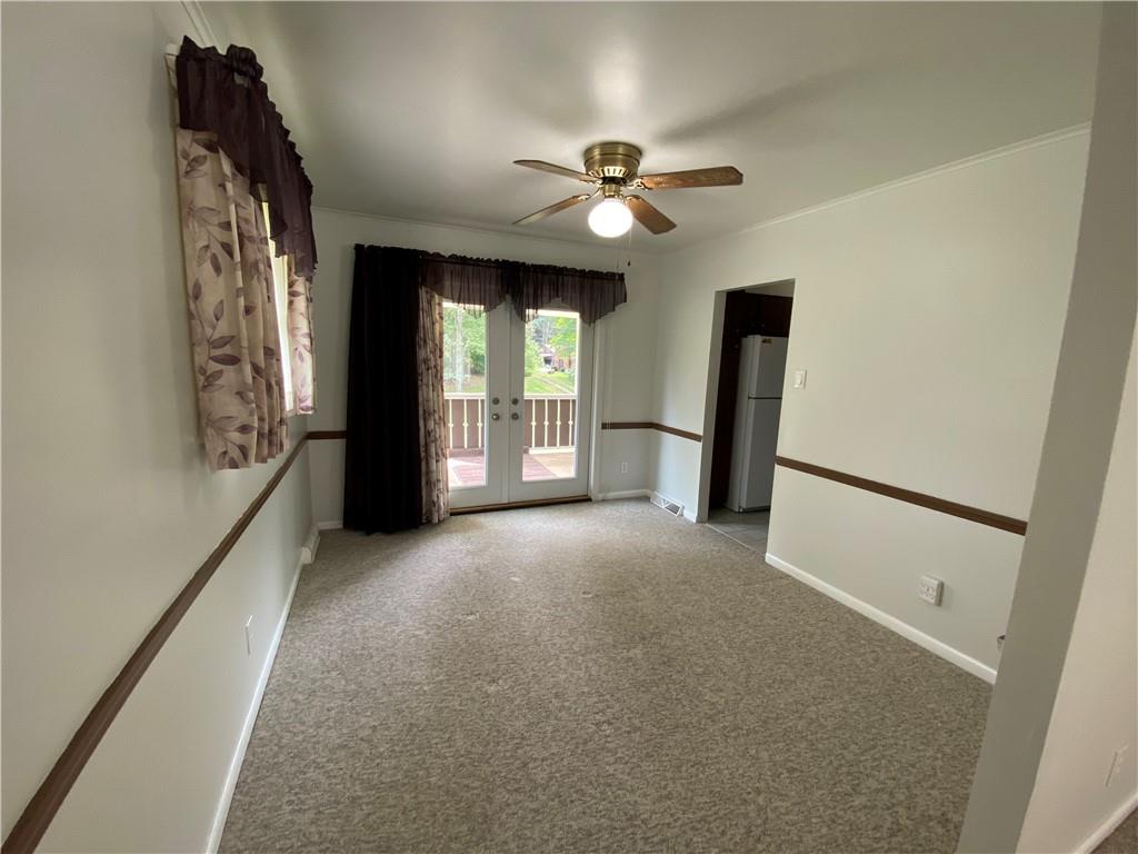 262 Thorne Run Road Export, PA 15632 - Photo 4 of 19 an empty room with chandelier fan and windows