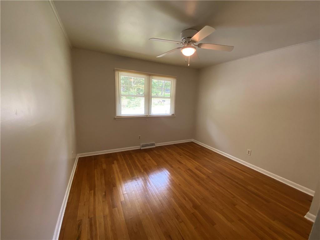 262 Thorne Run Road Export, PA 15632 - Photo 6 of 19 an empty room with wooden floor and windows