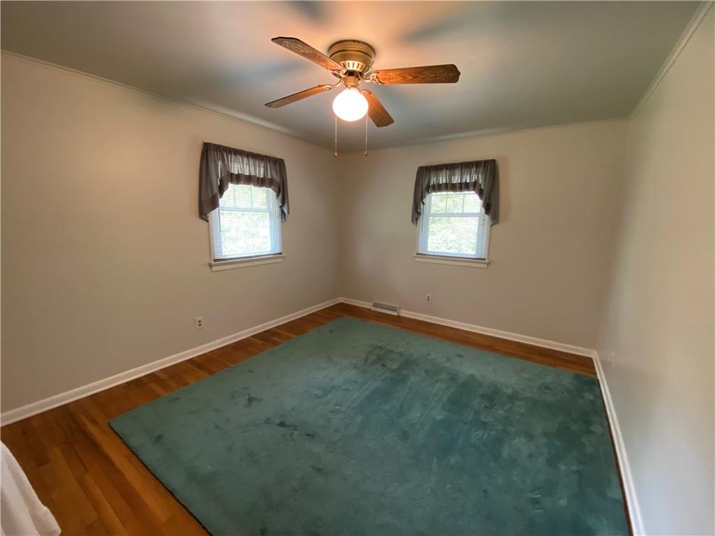 262 Thorne Run Road Export, PA 15632 - Photo 7 of 19 an empty room with windows and fan