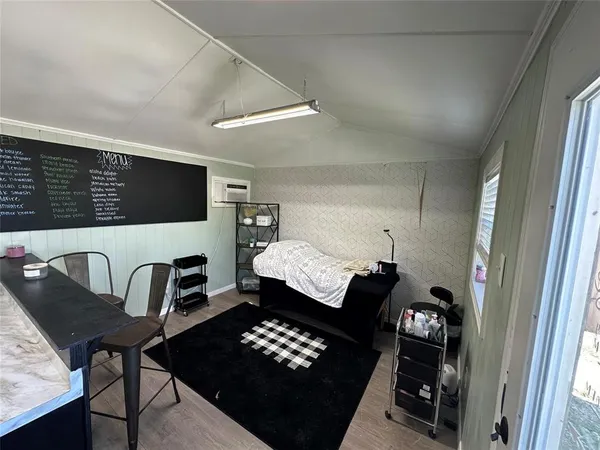 a bedroom with furniture and a window
