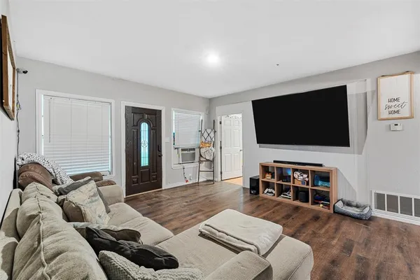 a living room with furniture and a flat screen tv