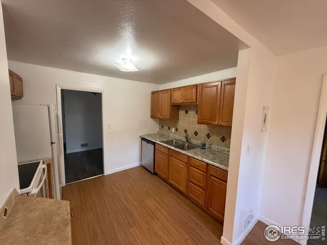 a kitchen with stainless steel appliances granite countertop a stove and a refrigerator