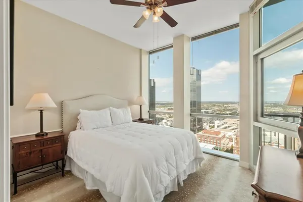 a bedroom with a bed and a lamp