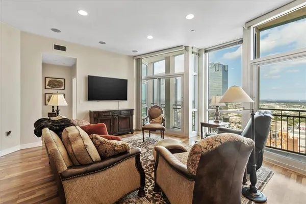 a living room with fireplace furniture and a flat screen tv