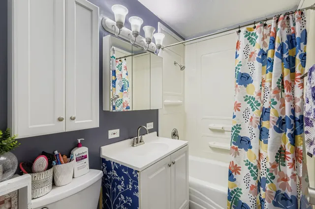 a bathroom with a sink vanity granite and toilet