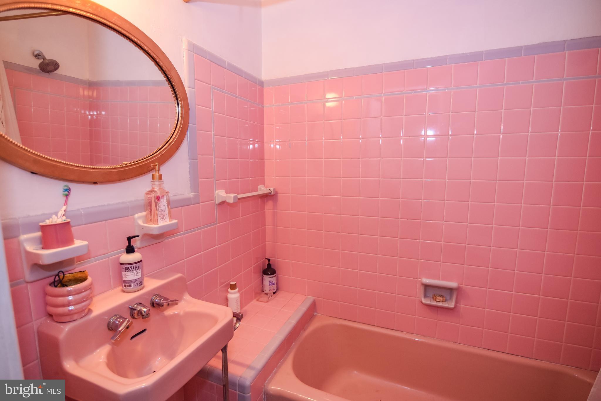 24 Merrymount Road Baltimore, MD 21210 - Photo 25 of 48 a bathroom with a sink a mirror and a bath tub