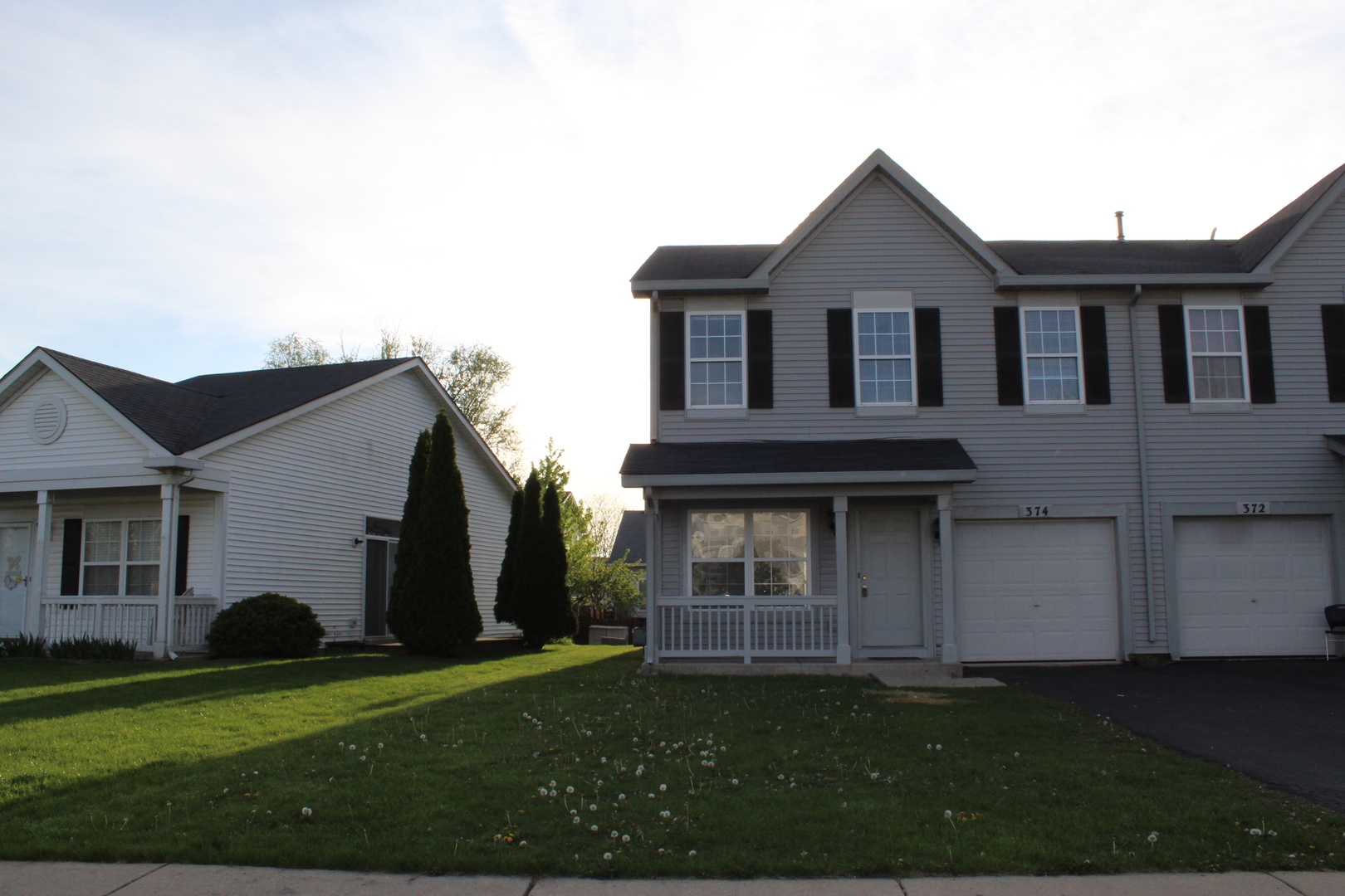 374 Reston Circle Romeoville, IL 60446 - Photo 1 of 11 a view of a yard in front of a house with large windows
