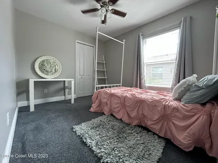a bed sitting in a bedroom next to a window